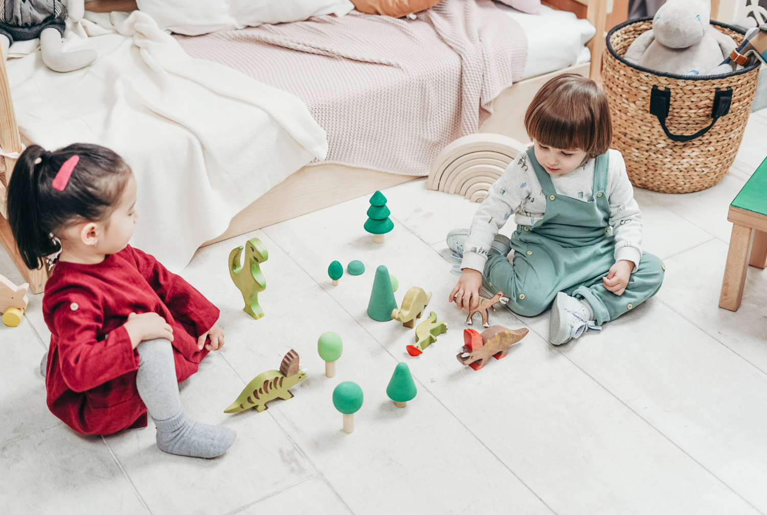 Two children playing with wooden toys